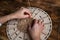 Woman weaves basket of paper tubes on wooden table. Process of weaving a decorative basket from tubes twisted from paper