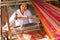 Woman weaving a craft at the village of Minnanthu