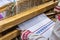 Woman weaving traditional slavic linen on horizontal loom.