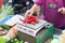 Woman is weighing chili peppers on the scales