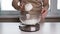 woman weighing flour in a plate on a kitchen scales, dough and pastry preparation