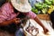 Woman weighing fresh fish on an old scale, local m