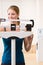 Woman weighing herself on scales in health club