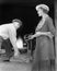 Woman weighing a piece of iron at a foundry