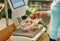 Woman weighing potatoes on scale at grocery store