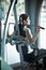 Woman weight training at gym.Exercising on pull down weight machine.Woman doing pull-ups exercising lifting dumbbells.Cardio and