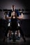 Woman weight training at gym.Woman doing pull-ups exercising lifting dumbbells