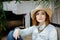 Woman in western wear in cowboy hat, jeans and cowboy boots.