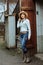 Woman in western wear in cowboy hat, jeans and cowboy boots.