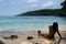 Woman with wet long hair enjoying and sunbathing on a pristine blue-green beach in southeast Asia