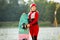 Woman in wetsuit, helmet and life vest walking with a wakeboard on a pier. Sunny summer day. Safety in sport. Water sport