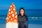 Woman in wetsuit with a surfboard on a sunny day