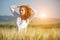 Woman in wheat field enjoying,