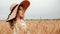 Woman wheat field nature. Happy young woman in sun hat in summer wheat field at sunset. Copy space, sunset, flare light