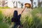 Woman at wheat field at sunset