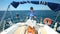 Woman at wheel steering sailboat on Adriatic sea in Croatia