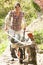 Woman With Wheelbarrow Working In Garden