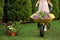 Woman with wheelbarrow working in garden