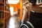 Woman in wheelchair with blurry college or university library in background