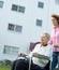 Woman in wheelchair with caregiver