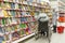 a woman in a wheelchair chooses a book for a child in the children`s department of the store.