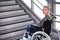 Woman in a wheelchair in front of stairs