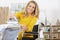 Woman in wheelchair ironing at home