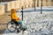 Woman in wheelchair relaxing in winter park.