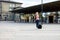 Woman With Wheeled Luggage Walking Outside Train Station