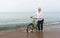 Woman wheeling her bicycle through the sea