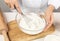 Woman whipping egg whites at wooden table. Baking pie