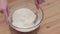 Woman whisking batter in kitchen