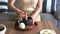 Woman whisking matcha green tea drink at home using tea ceremony set