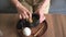 Woman whisking matcha green tea drink at home using tea ceremony set