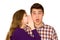 Woman whispering into man\'s ear