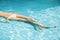Woman in white bikini floating in swimming pool