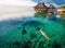 Woman in white bikini swimming in coral lagoon, Moorea, Tahiti