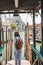 woman in white clothes with straw hat at pier basilica santa maria della salute on background