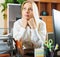 Woman in white dreaming at office desk