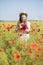 Woman at white dress adjust poppy bouquet