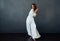Woman in white dress attractive glamor performance gray background