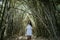 Woman in white dress enjoying nature in bamboo forest