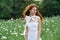 Woman in white dress in a field walk flowers vintage nature