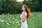 Woman in white dress in a field walk flowers vintage nature