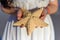 Woman in a white dress holds a starfish, hands closeup