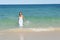 Woman in white dress in ocean