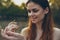 woman in white dress with a praying mantis in hand animals