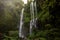 Woman in white dress at the Sekumpul waterfalls in jungles on Ba