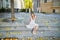 woman in white dress sitting on the stairs on famous Montmartre hill in Paris, France at early morning