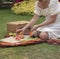 Woman in white dress slicing the fruits